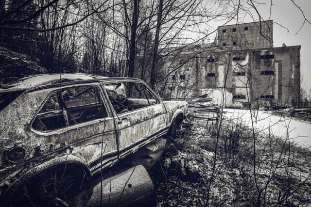 An old abandoned car facing an abandoned mine in Sweden