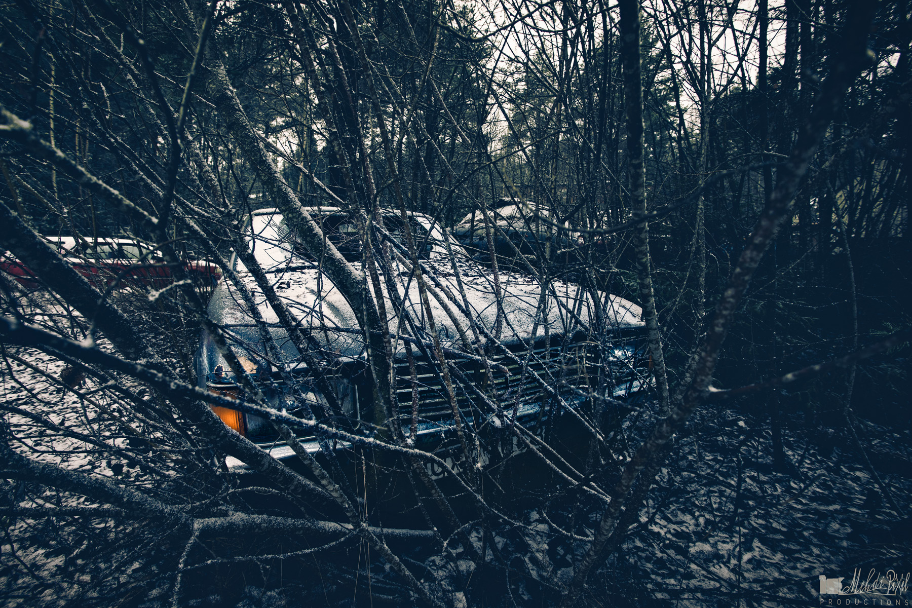 Old abandoned classic car crashed into a tree in an abandoned mine in Sweden in a snowy day